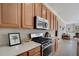 Modern kitchen with stainless steel oven and microwave, surrounded by light countertops and matching cabinets at 14205 Nighthawk Ter, Lakewood Ranch, FL 34202