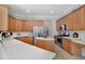 Bright kitchen featuring wood cabinets, stainless steel appliances, and a convenient center island at 14205 Nighthawk Ter, Lakewood Ranch, FL 34202