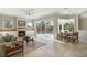 Open-concept living area features tile floors, a fireplace, and seamless access to the screened pool at 14205 Nighthawk Ter, Lakewood Ranch, FL 34202