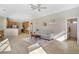 Open-concept living area with tile floors, comfortable seating, and seamlessly connecting living, kitchen, and dining areas at 14205 Nighthawk Ter, Lakewood Ranch, FL 34202