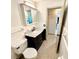 Bathroom featuring a toilet and a vanity with a marble countertop and a dark-colored cabinet at 1520 2Nd E Ave, Bradenton, FL 34208