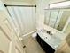 Bathroom features a vanity with a marble countertop and a shower with a white shower curtain at 1520 2Nd E Ave, Bradenton, FL 34208