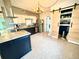 Bright kitchen featuring granite counters, stainless steel appliances, and a stylish, modern chandelier at 1520 2Nd E Ave, Bradenton, FL 34208