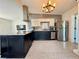 Modern kitchen with granite island, stainless steel appliances, and tile backsplash is well lit and inviting at 1520 2Nd E Ave, Bradenton, FL 34208