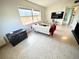 Cozy living room featuring a large window, comfortable seating, and a modern television for relaxation at 1520 2Nd E Ave, Bradenton, FL 34208