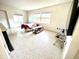 Bright living room with terrazzo flooring, natural light, and comfortable seating arrangement at 1520 2Nd E Ave, Bradenton, FL 34208