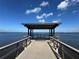 A wooden pier juts out into the water, offering a peaceful spot with bench seating and views of the water at 1520 2Nd E Ave, Bradenton, FL 34208