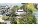 An aerial view of a beautiful waterfront home with lush landscaping, a tennis court, and mature trees at 1621 Memory Ln, Sarasota, FL 34231