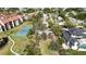 An aerial view of a lovely home in a residential area with mature trees, a tennis court and green lawns at 1621 Memory Ln, Sarasota, FL 34231