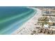 Stunning aerial view of the pristine white sandy beach and clear blue water along the coastline at 1621 Memory Ln, Sarasota, FL 34231