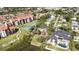Waterfront aerial view of the property featuring a tennis court, lush landscaping, and waterfront access at 1621 Memory Ln, Sarasota, FL 34231