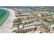 Expansive aerial view of beachside condos, community tennis courts, and waterways along the beautiful beach at 1621 Memory Ln, Sarasota, FL 34231