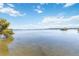 Beautiful bay view featuring calm waters, lush shoreline foliage, and a clear blue sky above at 1621 Memory Ln, Sarasota, FL 34231