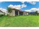 Spacious backyard with lush green lawn, screened lanai, and meticulous landscaping perfect for outdoor enjoyment at 16218 Umbria Pl, Bradenton, FL 34211