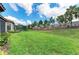 Expansive backyard featuring a well-manicured lawn and perimeter plantings, enclosed by a privacy fence at 16218 Umbria Pl, Bradenton, FL 34211