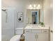 Well-lit bathroom featuring a shower and white vanity with a gray countertop at 16218 Umbria Pl, Bradenton, FL 34211