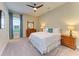 Inviting bedroom featuring a ceiling fan, two side tables with lamps, and a window with natural light at 16218 Umbria Pl, Bradenton, FL 34211