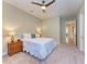 Neutral bedroom featuring ceiling fan, white bed linens and an ensuite bathroom at 16218 Umbria Pl, Bradenton, FL 34211