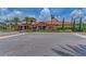 Beautifully landscaped clubhouse with a tile roof and stone accents, surrounded by lush greenery and palm trees at 16218 Umbria Pl, Bradenton, FL 34211