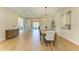 Elegant dining room features a stylish chandelier and seating for six, bathed in natural light at 16218 Umbria Pl, Bradenton, FL 34211