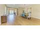Stylish dining room with wood-look tile flooring and an elegant light fixture at 16218 Umbria Pl, Bradenton, FL 34211