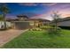 Charming single-story home with a well-manicured lawn, beautiful landscaping, and a tile roof at 16218 Umbria Pl, Bradenton, FL 34211