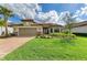 Charming single-story home with a well-manicured lawn, beautiful landscaping, and a tile roof at 16218 Umbria Pl, Bradenton, FL 34211