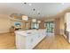 Bright kitchen with a large island, stainless steel appliances, and access to the outdoor area at 16218 Umbria Pl, Bradenton, FL 34211