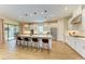 Modern open kitchen with an island featuring bar seating and stylish pendant lights at 16218 Umbria Pl, Bradenton, FL 34211