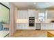 Modern kitchen featuring stainless steel appliances and a door to the outside patio at 16218 Umbria Pl, Bradenton, FL 34211