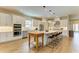 Well-equipped kitchen with stainless appliances, large island, and tiled backsplash at 16218 Umbria Pl, Bradenton, FL 34211