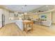 Well-lit open kitchen with white cabinetry, a center island, and seamless flow to the living space at 16218 Umbria Pl, Bradenton, FL 34211