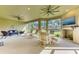 Expansive lanai featuring multiple seating areas, a fireplace with a television and a view of the lawn at 16218 Umbria Pl, Bradenton, FL 34211