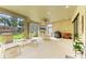 Relaxing screened-in lanai with comfortable seating, an outdoor kitchen, and tranquil views of the lush backyard at 16218 Umbria Pl, Bradenton, FL 34211