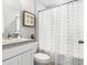 Cozy bathroom features a stylish shower curtain, simple vanity and minimalistic decorations at 16275 Banyan Ave, Port Charlotte, FL 33954