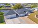 Stunning aerial view of a canal-front home with a paver driveway, separate garage, and nicely landscaped yard at 1950 Fairview Dr, Englewood, FL 34223