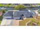 Beautiful aerial view of a canal-front home with a pool, and a separate garage, and nicely landscaped yard at 1950 Fairview Dr, Englewood, FL 34223