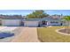Charming single-story home boasting a paver driveway, separate garage, and freshly landscaped yard at 1950 Fairview Dr, Englewood, FL 34223