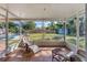 Screened porch with seating overlooking a backyard, pool, and shed at 205 45Th W St, Bradenton, FL 34209