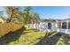 Grassy backyard with a wood fence, offering privacy and a serene outdoor space at 2312 Java Plum Ave, Sarasota, FL 34232