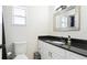 Bright bathroom with a black granite countertop and a modern vessel sink at 2312 Java Plum Ave, Sarasota, FL 34232