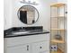 Bathroom featuring sleek vanity with black countertop, light fixture and shelf at 2312 Java Plum Ave, Sarasota, FL 34232