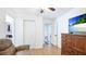 Bedroom featuring wood floors, white walls and closet doors and wood dresser at 2312 Java Plum Ave, Sarasota, FL 34232