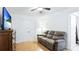 Bright bedroom with a ceiling fan, hardwood floors, and double door closet at 2312 Java Plum Ave, Sarasota, FL 34232