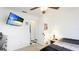 Bedroom featuring a flat screen television and view into attached bathroom at 2312 Java Plum Ave, Sarasota, FL 34232