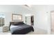 Bright bedroom with a large bed and a view into the walk in closet at 2312 Java Plum Ave, Sarasota, FL 34232