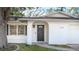 Inviting front door with an archway and modern black hardware at 2312 Java Plum Ave, Sarasota, FL 34232