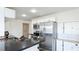 Updated kitchen with stainless steel fridge and sink and black and white checkered tile floor at 2312 Java Plum Ave, Sarasota, FL 34232