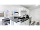 Kitchenette with granite countertops, stainless steel sink, and modern white cabinets at 2312 Java Plum Ave, Sarasota, FL 34232