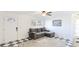 Cozy living room with a comfortable gray sectional couch and eye-catching black and white checkered floors at 2312 Java Plum Ave, Sarasota, FL 34232